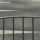 Fence rail cropped at JPG q=50 — faint ghost edges (ringing) starting around the rail